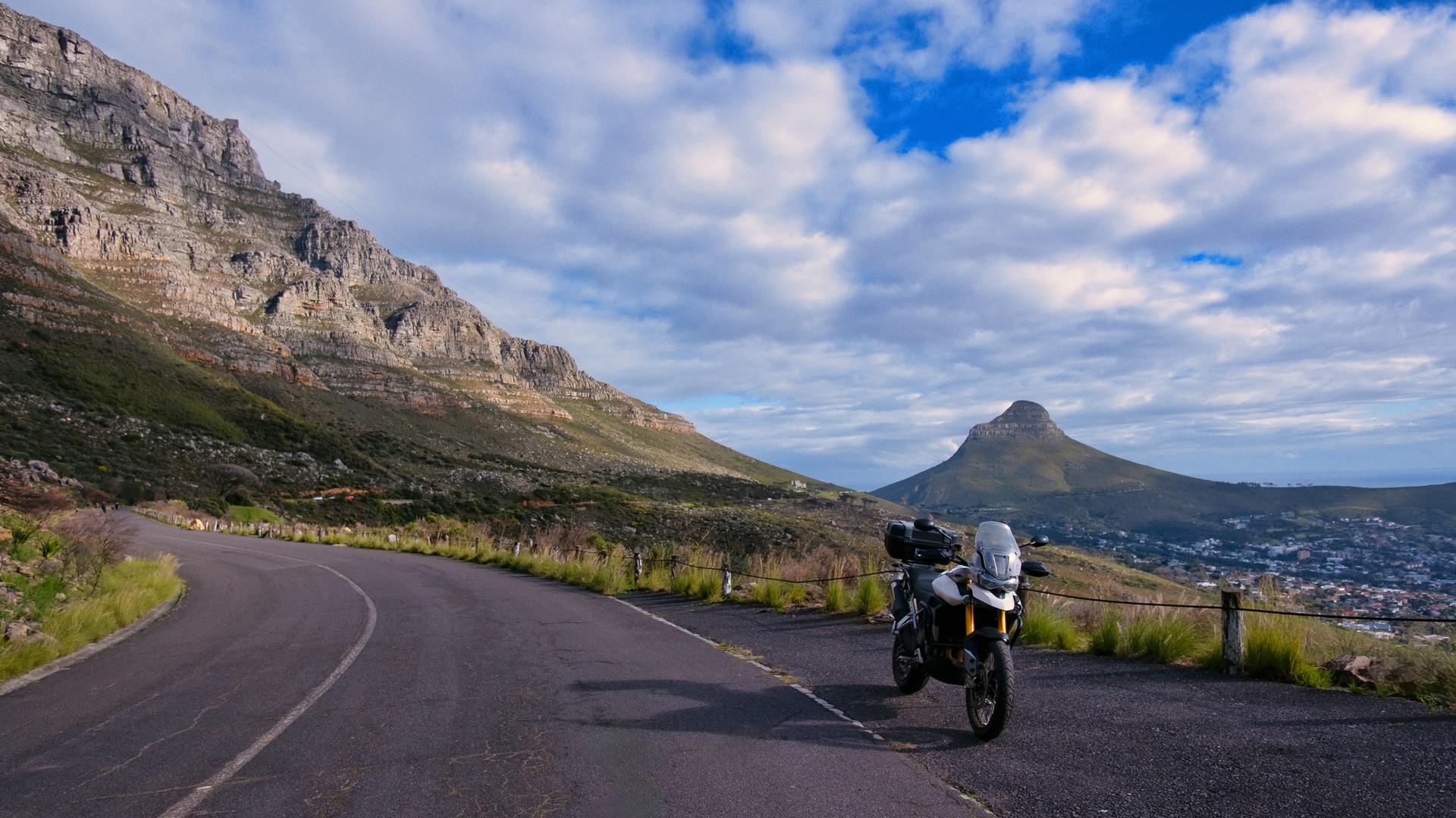Мотоцикл на живописной обзорной площадке с горой Львиная голова и городом Кейптауном.