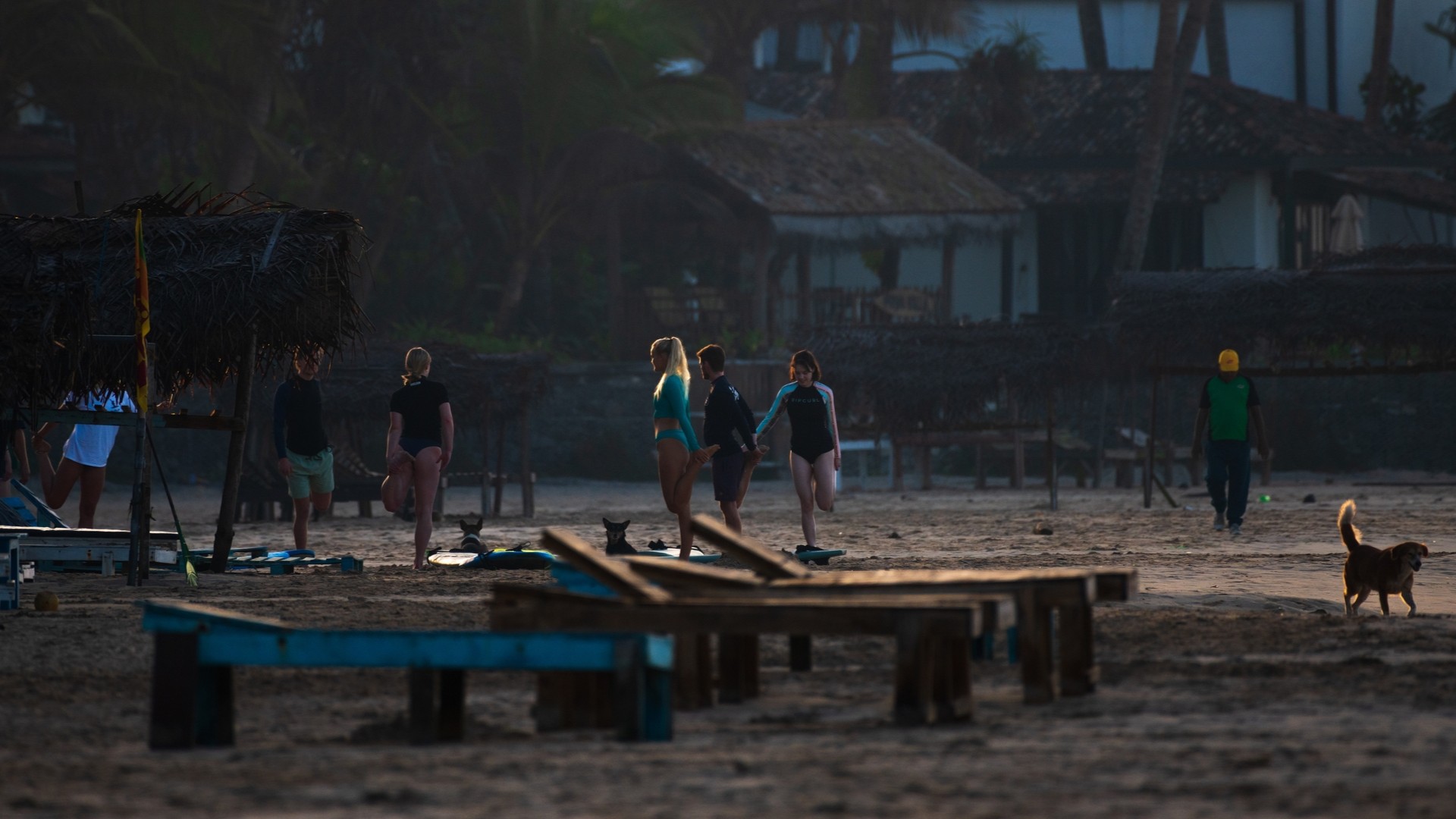 Серферы делают раминку перед заплывом на пляже Кабаланы.